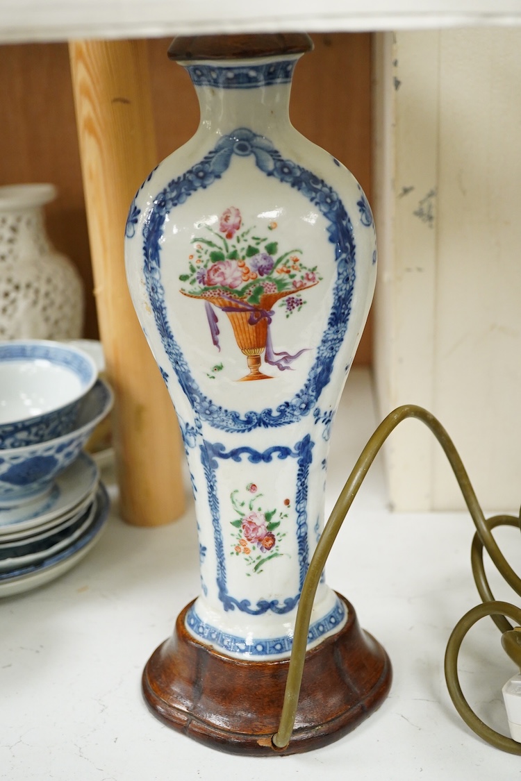 Two Chinese famille rose vases from a garniture, Qianlong period (1736-95), mounted as table lamps with shades, raised on shaped wood bases, overall 62cm high